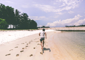 Man running on a beach on a sunny day