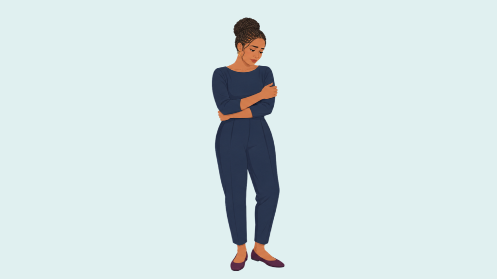 Woman gently holding herself while experiencing grief after miscarriage.